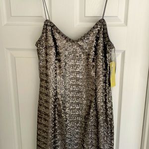 Silver sequined short dress with spaghetti straps-jeweled around neckline.